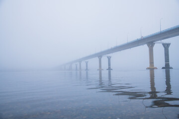 Bridge over the river in heavy fog