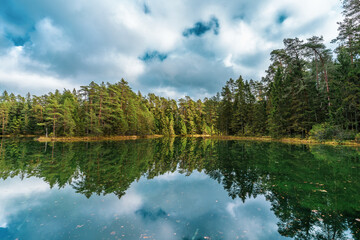 Fototapeta premium Beautiful blue lake in woods. autumn landscape.