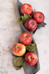 Ripe red apples on grey background, space for text