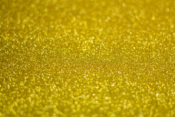Universal celebration background,  perfect for Christmas or New Year, yellow glitter, selective focus
