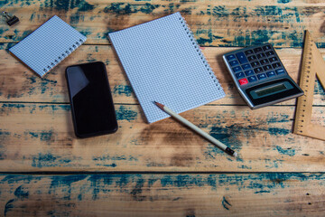 Fototapeta na wymiar Top view of accountant desk with calculator, smart phone and pen