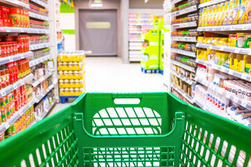 close up and first person or pov view of a cart buying products and food in a empty supermarket