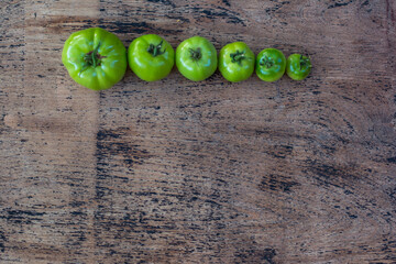 green tomatoes on the wood