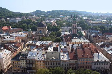 Fototapeta na wymiar View from the height of the City Hall to the ancient buildings of Lviv. Ukraine. European architecture. Architectural monuments. Dominican Cathedral