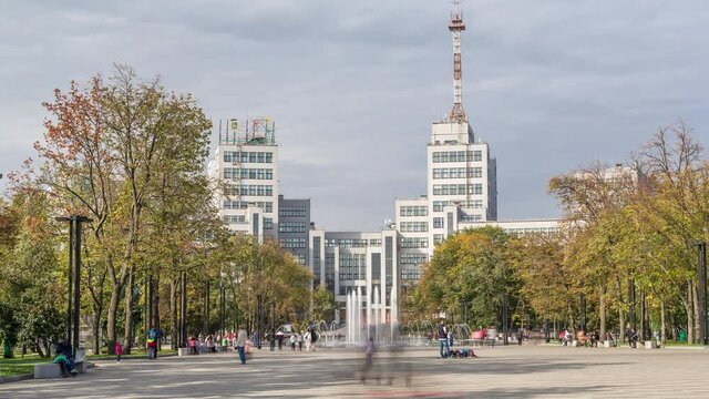 Gosprom building on the Freedom square with new dry fountain with people walking in park in Kharkov city timelapse, Ukraine. Walking area around