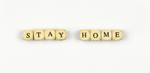 Lettering STAY HOME with wooden beads on white background