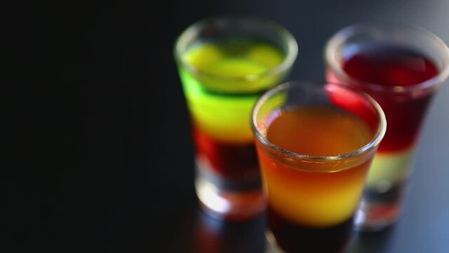 Three alcoholic Mexican shots for party in bar.Colorful alcohol served in three shot glasses on bar stand