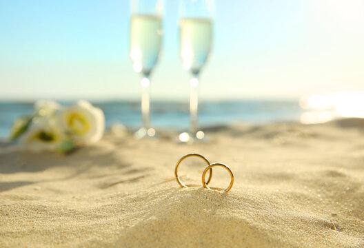 Beautiful gold wedding rings on sandy beach