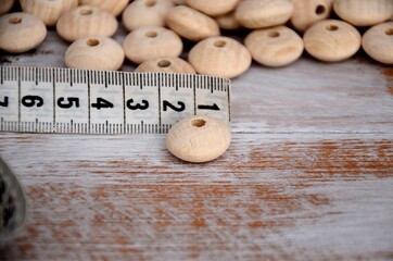 Abacus wood beads on the table and measurement. Unfinished natural wooden beads 