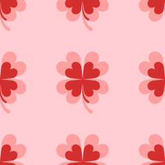 Seamless pattern of large isolated red four-leaf clover symbols. The elements are evenly spaced. Vector illustration on light red background