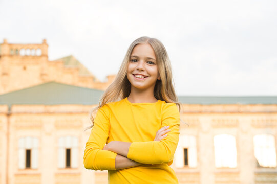 Confident girl child with beauty look in casual fashion style keep arms crossed standing urban outdoors, confidence - Powered by Adobe