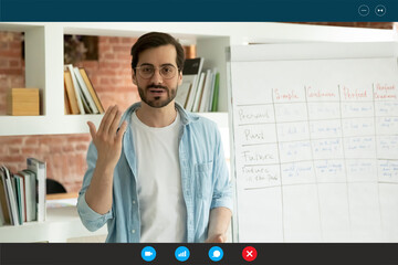Computer video call app screen view, professional male tutor in eyeglasses giving online...