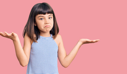 Young little girl with bang wearing casual clothes clueless and confused expression with arms and hands raised. doubt concept.