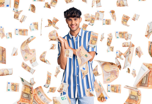 Young hispanic man wearing casual clothes clapping and applauding happy and joyful, smiling proud hands together
