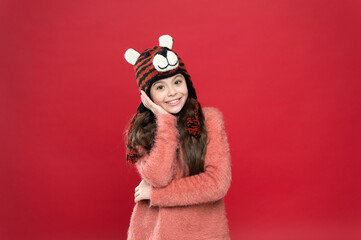 smiling teen girl in cozy warm wear winter hat, daydreamer