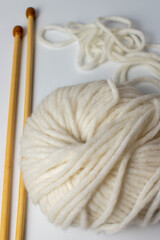 winter white soft knitting yarn and wooden needles