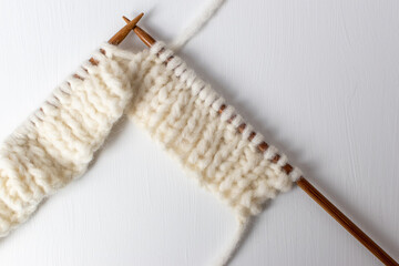 bamboo wood knitting needles and white alpaca blend yarn