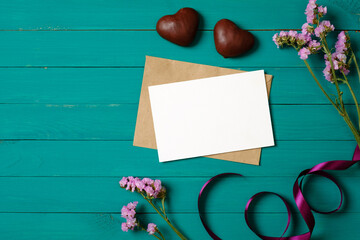 Love letter blank paper card and flower on wooden background