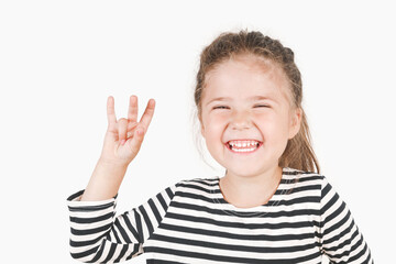 Laughing girl with three fingers up, showing Number three. Close up of posing little girl wearing a striped shirt, looking at the camera on an isolated background. Learning with a fun concept.
