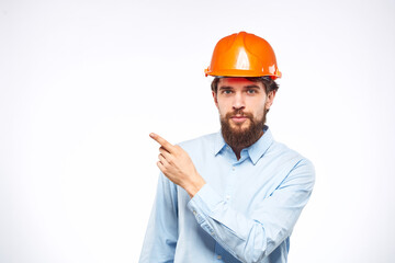 Man in orange hard hat industry engineer work professional light background