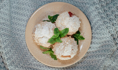 Muffins on blue background with sugar powder