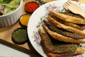 Toast from wholemeal bread with roasted parasol mushroom and vegetable salad and some spices. Served on the wooden desk and ceramic plate. Perfect quick breakfast in autumn season.