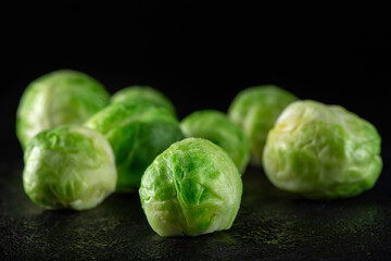 Fresh brussels sprouts on dark slate