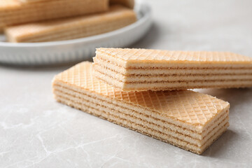Delicious cream wafers on light grey marble table, closeup