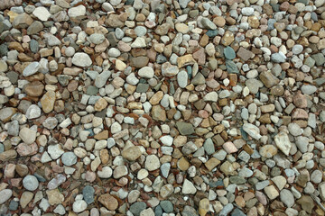 a close up view of a stone pebble rock gravel garden path backyard trail suitable for background backdrop also like a footpath walkway park featuring overhead detail textured surface pattern