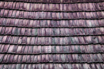 old roof made of wood. wooden background. texture with roof tiles. a lot of folded boards
