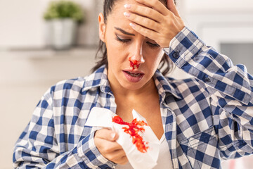 Woman find out her nose is bleeding after sneezing into a tissue