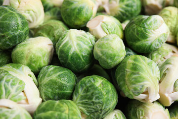 Fresh tasty Brussels sprouts as background, closeup