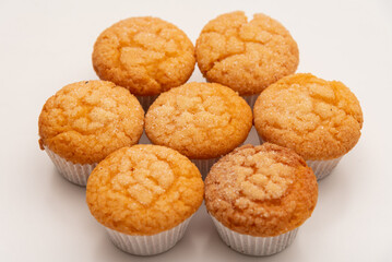 Freshly baked tasty sugar coated muffin on a white table