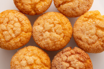 Freshly baked tasty sugar coated muffin on a white table