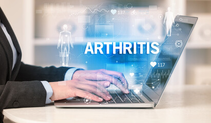 Doctor working a health check with ARTHRITIS inscription, recording medical test results
