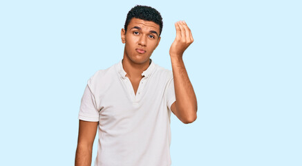 Young arab man wearing casual clothes doing italian gesture with hand and fingers confident expression