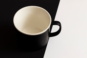 Top view of empty coffee cup on black and white background.