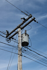 Utility pole with transformer and power lines