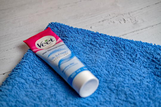 Norwich, Norfolk, UK &ndash; November 14 2020. Illustrative photo of a plastic tube of Veet hair removal cream on a blue towel
