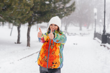 A young athletic girl does sports on a frosty and snowy day and shows class. Fitness, running