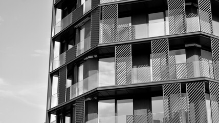 Fototapeta premium Detail of modern residential flat apartment building exterior. Fragment of new luxury house and home complex. Black and white.