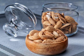 Roasted salted almonds lie on a light background.