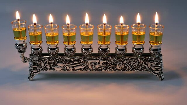 Lighting oil candles in menorah for Hanukkah in the Jewish Festival