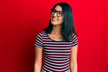 Fototapeta premium Beautiful asian young woman wearing casual clothes and glasses looking to side, relax profile pose with natural face and confident smile.