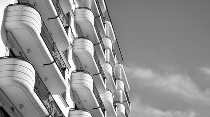 Detail of modern residential flat apartment building exterior. Fragment of new luxury house and home complex. Black and white.