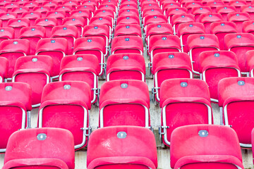 Naklejka premium empty red chairs in the outdoor arena