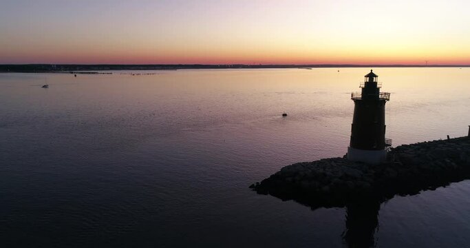 Sunrise over the Delaware Bay with a Lighthouse, off the coast of Cape May, aerial drone shot