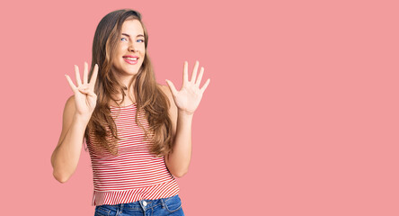 Beautiful caucasian young woman wearing casual clothes showing and pointing up with fingers number nine while smiling confident and happy.