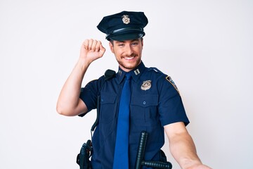 Young caucasian man wearing police uniform dancing happy and cheerful, smiling moving casual and confident listening to music