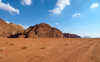 Desert rock mountain, red sand and blue sky